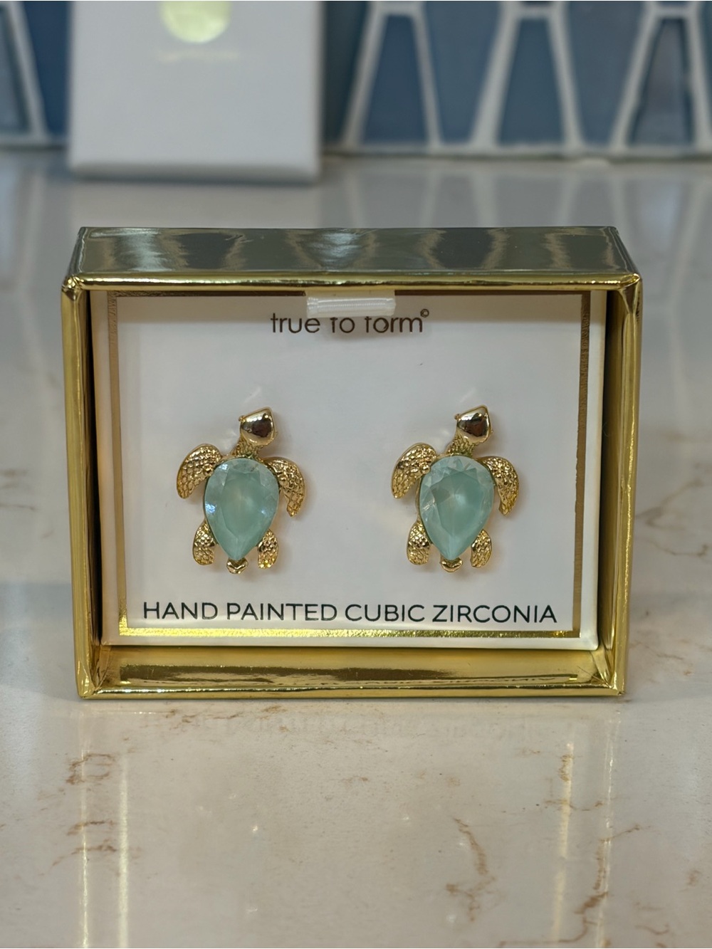 true to form Gold Turtle Stud Earrings with Light Aqua Stones